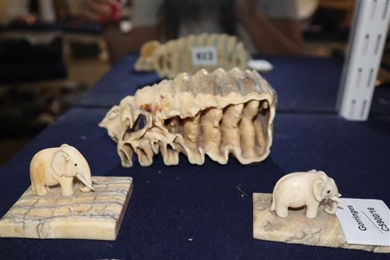 Two ivory elephant figures with elephant tooth stands and two elephant tooth specimens, early 20th century,